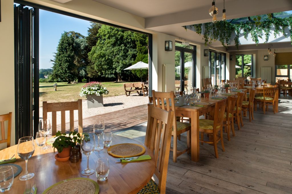 Dining seating with views of the grounds at the pear at parley bar and restaurant in west parley, ferndown, dorset